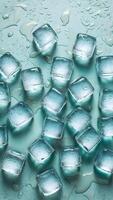 Translucent ice cubes on blue surface with water droplets, creating refreshing ambiance Vertical Mobile Wallpaper photo