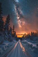 Snow Covered Road Leading Through a Winter Forest at Night With the Milky Way photo