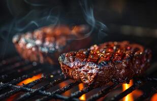 Close Up of Two Seasoned Steaks Grilling Over Hot Coals photo