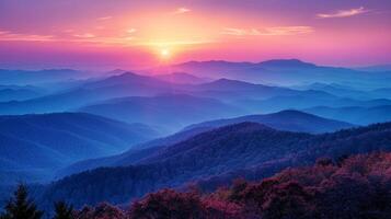 Sun Setting Over Mountains With Purple Flowers photo
