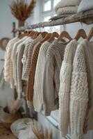 Row of Sweaters Hanging on Rack photo