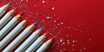 Pencils Arranged on Red Surface photo