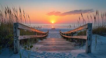 Wooden Pathway Leading to the Ocean at Sunset photo