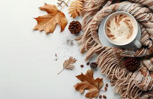 Brown Knit Scarf With Autumn Leaves and Pinecones on a White Background photo