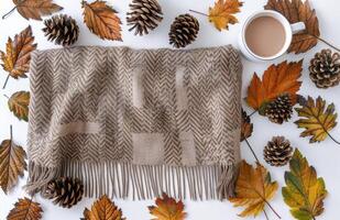 Brown Knit Scarf With Autumn Leaves and Pinecones on a White Background photo