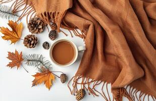Brown Knit Scarf With Autumn Leaves and Pinecones on a White Background photo