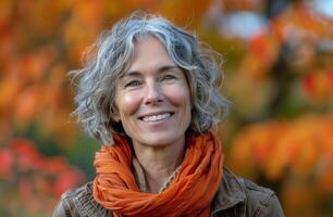 Smiling Woman With Short Grey Hair Wearing Orange Scarf in Autumn photo