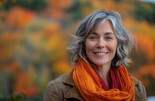 Smiling Woman With Short Grey Hair Wearing Orange Scarf in Autumn photo