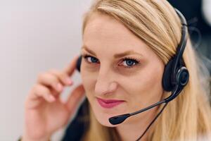 Friendly Call Center Agent Answering Incoming Calls with Headset Providing Remote Customer Service. photo
