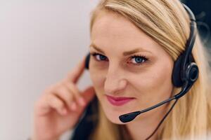 Friendly Call Center Agent Answering Incoming Calls with Headset Providing Remote Customer Service. photo