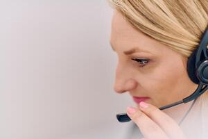 Friendly Call Center Agent Answering Incoming Calls with Headset Providing Remote Customer Service. photo