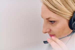 Friendly Call Center Agent Answering Incoming Calls with Headset Providing Remote Customer Service. photo