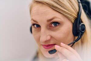 Friendly Call Center Agent Answering Incoming Calls with Headset Providing Remote Customer Service. photo