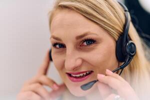 Friendly Call Center Agent Answering Incoming Calls with Headset Providing Remote Customer Service. photo