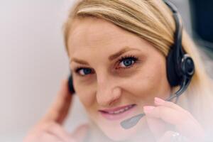 Friendly Call Center Agent Answering Incoming Calls with Headset Providing Remote Customer Service. photo