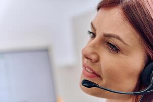 Friendly Call Center Agent Answering Incoming Calls with Headset Providing Remote Customer Service. photo