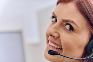 Friendly Call Center Agent Answering Incoming Calls with Headset Providing Remote Customer Service. photo