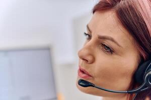 Friendly Call Center Agent Answering Incoming Calls with Headset Providing Remote Customer Service. photo