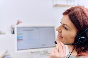 Friendly Call Center Agent Answering Incoming Calls with Headset Providing Remote Customer Service. photo