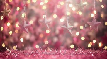 Silver Star Ornaments Hanging Against Pink Bokeh Background photo