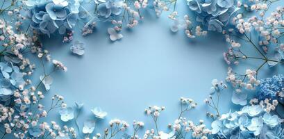 Blue Hydrangeas and Delicate White Flowers Frame a Light Blue Background photo