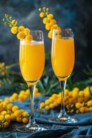 Two Glasses of Mimosa With Mimosa Flowers on a Blue Tablecloth photo