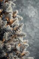 Decorated Christmas Tree With Lights and Ornaments Against a Grey Wall photo