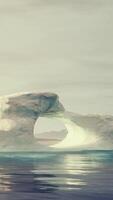 A large iceberg floating in the middle of the ocean video
