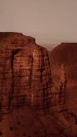 A large rock formation in the middle of a desert video
