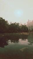 A body of water surrounded by trees and rocks video