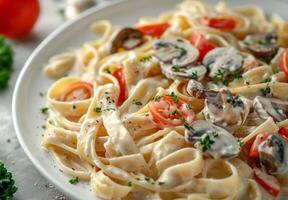 Creamy Mushroom Fettuccine Pasta With Herbs and Tomato photo