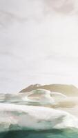 A group of icebergs floating on top of a body of water video