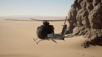 A helicopter flying over a desert with a rock formation in the background video