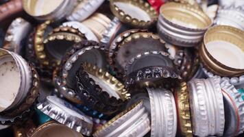 Assorted bottle caps create a colorful background, ideal for beverage, beer, and soda designs video
