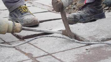 A group of workers using a jackhammer to break and remove concrete sections on a construction site video
