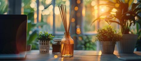 Reed Diffuser Scented Oil on Wooden Table With Plants and Laptop in Background photo