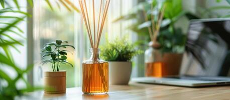 Reed Diffuser Scented Oil on Wooden Table With Plants and Laptop in Background photo