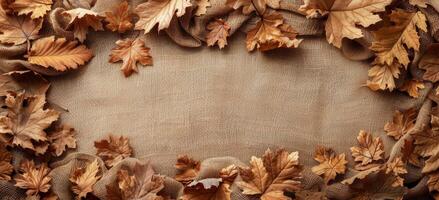 Dried Autumn Leaves Frame on Rustic Burlap Fabric Background photo