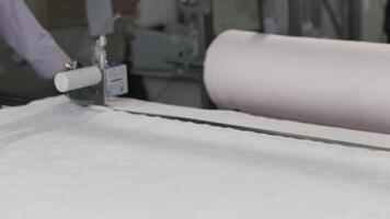 Textile manufacturing uses a Fabric Cutting Machine for precise cutting to increase efficiency video