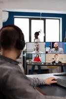 editor director talking with creative team in web online meeting on call editing client work, getting feedback on commercial movie using post production software on pc in creative office photo
