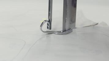 A detailed view of a fabric cutting machine being used with precision in a textile industry setting video