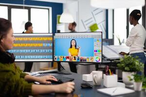 Freelancer retoucher woman working on computer with photo editing software. Professional graphic editor retouching assets of client with stylus pencil and two monitors in creative multimedia company