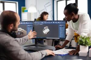 Diverse team of engineer architects working on modern cad program developing construction metalic components. Industrial designer studying prototype idea on pc showing digital software with gears photo