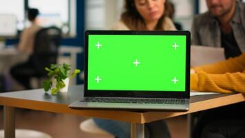 Businesspeople analysing annual financial reports sitting at desk in back of laptop with green screen monitor. Leader explainig project strategy using greenscreen pc with chroma key display. photo
