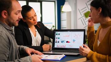 Business people talking with team leader using clipboard with documents pointing on it, presenting startup financial ideas to manager, brainstorming project management strategy in company office photo