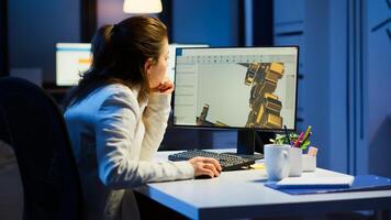 Tired woman architect working on modern cad program overtime sitting at desk in start-up office. Industrial female engineer studying prototype idea on pc showing cad software on device display photo