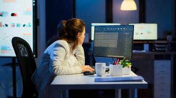 Tired engineer analysing cad software to design a 3D concept of container working overtime in start-up company for prototype. Overworked woman studying in office new modern model using technology photo