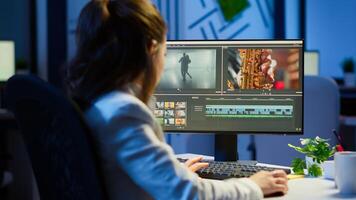 editor working at night at new project editing audio film montage sitting in start-up business office. Woman content creator using professional computer, modern technology, network wireless photo