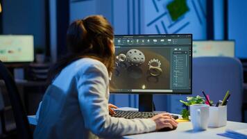 Woman architect working in modern cad program overtime sitting at desk in start-up business office. Industrial employee studying prototype idea on computer showing cad software on device display photo