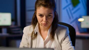 Close up of exhausted manager working overtime to respect deadline of project sitting in business office typing on laptop late at night. Focused employee using modern technology network wireless photo